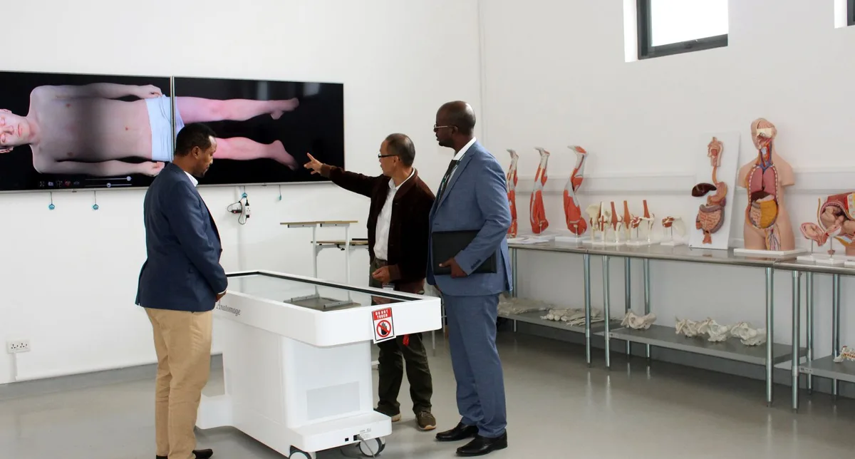 Doctors reviewing anatomy on a large interactive medical display