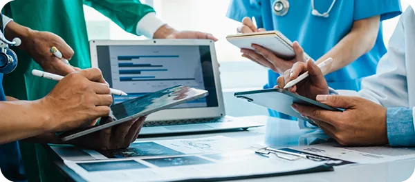 Healthcare professionals review patient information on tablets