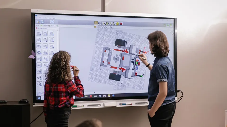 Students designing together on an interactive display
