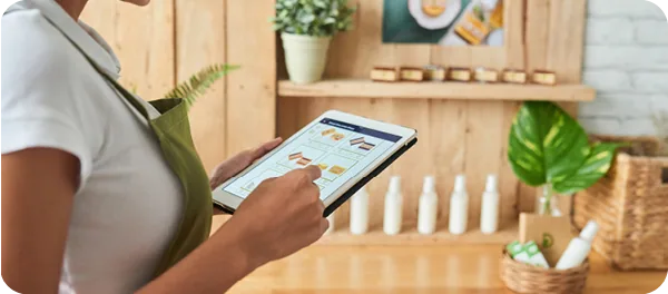 Retail employee manages inventory on a tablet