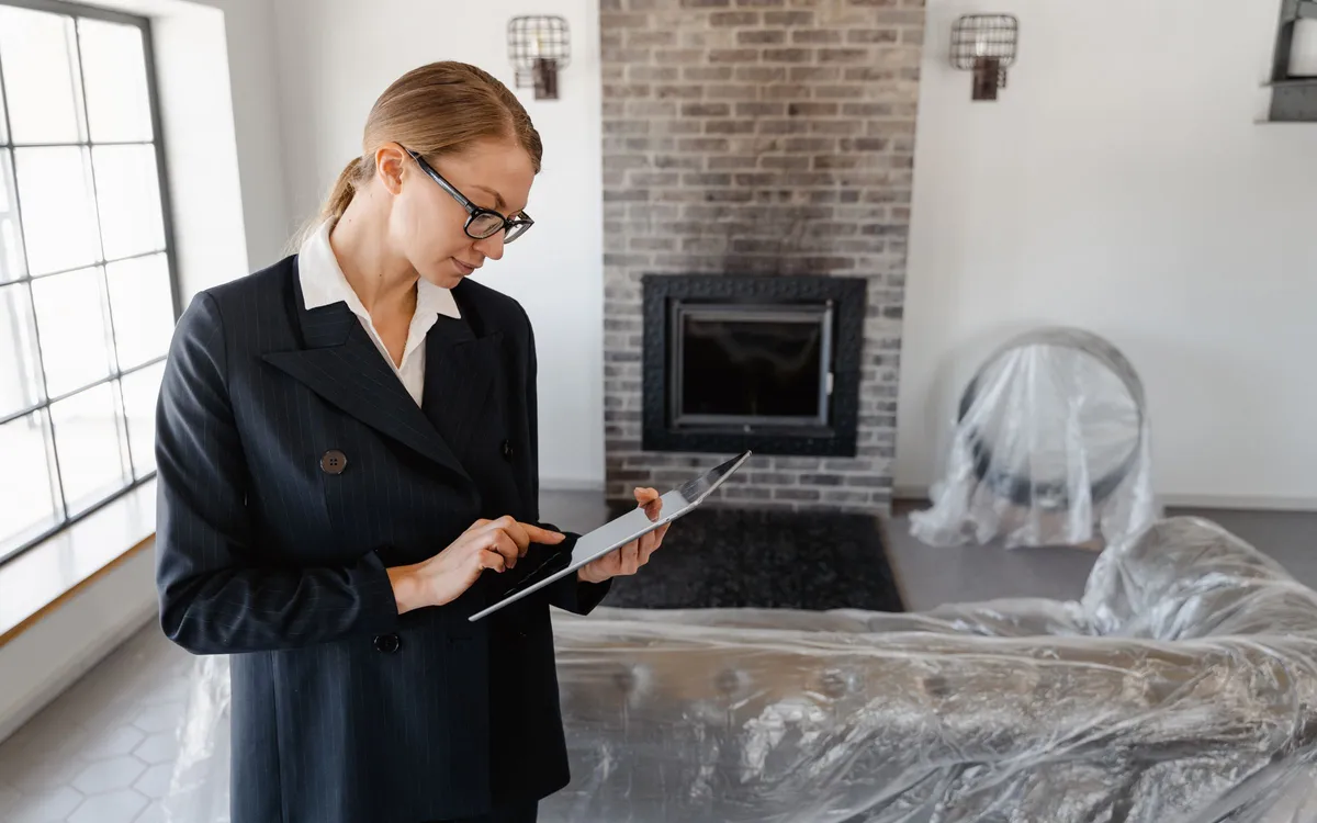 Property manager reviewing building details on a tablet during a site walkthrough